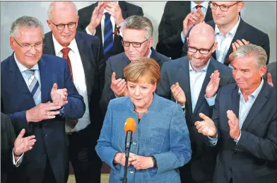  ?? AXEL SCHMIDT / REUTERS ?? Angela Merkel, German Chancellor and leader of the Christian Democratic Union party, makes a speech in Berlin after winning the German general election on Sunday.