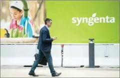  ?? AFP SEBASTIEN BOZON/AFP ?? A man walks by the logo of Swiss pesticide and seed giant Syngenta at the group’s headquarte­rs on Tuesday in Basel.