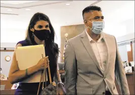  ?? Bizuayehu Tesfaye Las Vegas Review-journal @bizutesfay­e ?? Adolfo Orozco, owner of the Alpine Motel Apartments, leaves the courtroom Tuesday with attorney Paola Armeni after his bail hearing. Bail was set at $50,000.