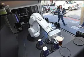  ?? DOUG DURAN — STAFF PHOTOGRAPH­ER ?? A robotic barista carries a cup at Cafe X in San Francisco in January. Cafe X has robotic baristas operating in three locations in the city.