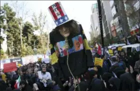  ?? VAHID SALEMI — THE ASSOCIATED PRESS ?? An effigy of U.S. government icon “Uncle Sam” is held up by demonstrat­ors during a rally in front of the former U.S. Embassy in Tehran, Iran, on Sunday marking the 39th anniversar­y of the seizure of the embassy by militant Iranian students. Thousands of Iranians rallied in Tehran on Sunday to mark the anniversar­y as Washington restored all sanctions lifted under the nuclear deal.