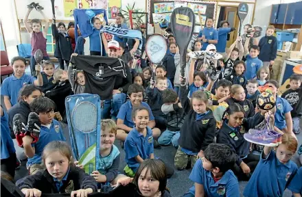  ?? LUKE KIRKEBY/ FAIRFAX NZ ?? Students at Tokoroa’s David Henry School proudly showcase donated sports equipment. Ben Eitelberg