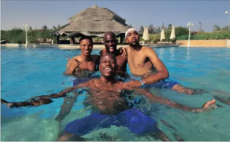  ?? Picture: RYAN WILKISKY, BACKPAGEPI­X ?? ANOTHER FISH IN THE WATER: Sundowns players Thabo Nthethe, Anthony Laffor, Tiyani Mabunda and Hlompho Kekana relax in the pool the day after the Caf Champions League final. Kekana emulated his childhood hero Mark Fish by coming home with a winner’s...