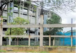  ??  ?? Rusted iron beams and wild grass has invaded the place that should have been a swimming pool by now