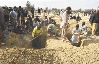  ?? Banaras Khan / AFP / Getty Images ?? Residents dig graves for the victims of a suicide bombing of a church in Quetta, Pakistan. Nine people died in the attack, which was claimed by an Islamic State affiliate in Pakistan.