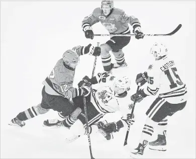  ?? BOB TYMCZYSZYN THE ST. CATHARINES STANDARD ?? North Bay’s David Maier (12) knocks down Niagara’s Andrew Bruder in Ontario Hockey League action Friday night at Meridian Centre inSt. Catharines.