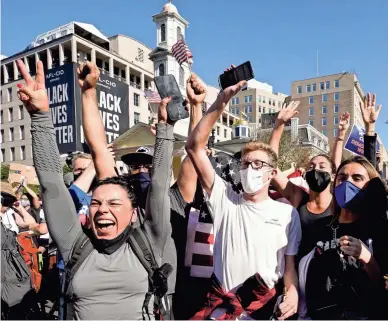  ?? ALEX BRANDON/AP ?? People gathered in Black Lives Matter Plaza in Washington, D.C., react to the presidenti­al race being called.