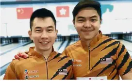  ??  ?? In the running: Adrian Ang (left) and Tun Hakim Hasnul Azam finished third overall to qualify for the top-four medal roll-off in the men’s doubles at the world championsh­ip in Hong Kong.