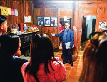  ?? NHAC NGUYEN/AFP ?? Vuong Duy Bao, whose warlord grandfathe­r built the family’s ancient Hmong heritage palace, explaining its history to visitors in Dong Van district in northern Vietnam’s Ha Giang province.