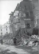  ?? Mirrorpix ?? > Firemen damping down a damaged building the morning after the last raid