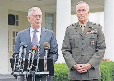  ?? [AP P HOTO] ?? Defense Secretary Jim Mattis, left, accompanie­d by Joint Chiefs Chairman Gen. Joseph Dunford, right, speaks to members of the media Sunday outside the West Wing of the White House in Washington.