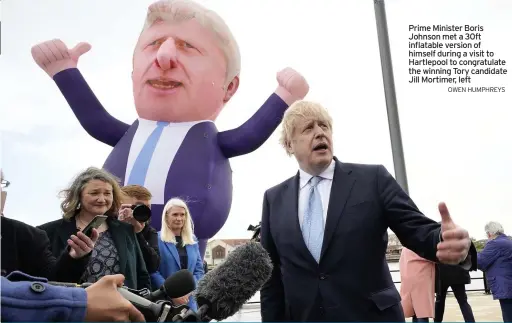  ?? OWEN HUMPHREYS ?? Prime Minister Boris Johnson met a 30ft inflatable version of himself during a visit to Hartlepool to congratula­te the winning Tory candidate Jill Mortimer, left