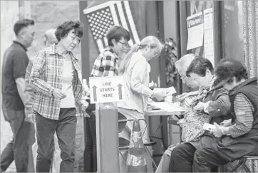  ?? Irfan Khan Los Angeles Times ?? L.A. COUNTY officials have proposed a replacemen­t system that features a prototype electronic, touchscree­n ballot marker and an open-source software platform for tallying. Above, voters in Koreatown in June.