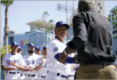  ?? ASHLEY LANDIS - THE ASSOCIATED PRESS ?? Los Angeles Dodgers’ manager Dave Roberts, center, shakes hands with David Robinson, son of Jackie Robinson, before a baseball game between the Cincinnati Reds and the Los Angeles Dodgers in Los Angeles, Friday, April 15, 2022.