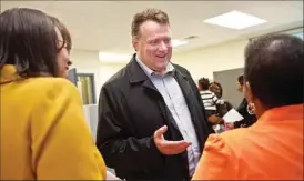  ?? METRO HALIFAX ?? Mayoral candidate Mike Savage talks to community members at an RCMP unit office opening in North Preston Wednesday.