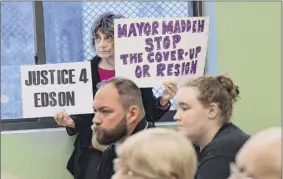  ??  ?? A woman protesting the city’s handling of the 2016 Edson Thevenin shooting listens to the mayoral debate, held at the Lansingbur­gh Boys and Girls Club.