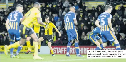  ??  ?? Scott Fraser watches as his 81stminute shot heads towards the net to give Burton Albion a 2-0 lead.