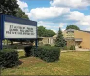  ?? DIGITAL FIRST MEDIA FILE PHOTO ?? This sign outside the former St. Pius X High School School on North Keim Street helped spread the word about the move by St. Aloysius Parish School.