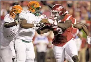  ?? NWA Democrat-Gazette/BEN GOFF ?? McTelvin Agim (3) will start practice as a defensive end for the Arkansas Razorbacks, but he could line up at various positions to create matchup problems for opposing offenses.