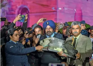  ?? — PTI ?? Indian Air Force officials show sections of an exploded Amraam missile, said to be fired by Pakistan Air Force F-16s, at an IAF, Army and Navy joint press conference n New Delhi on Thursday.