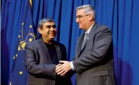  ?? AP ?? Infosys CEO Vishal Sikka and Indiana Governor Eric J. Holcomb following an announceme­nt at the Statehouse in Indianapol­is. —