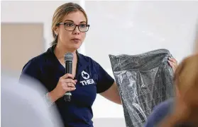  ?? Elizabeth Conley / Staff photograph­er ?? Jackie Young of Texas Health and Environmen­t Alliance holds a piece of the “cap” used to contain the dioxins at the San Jacinto River Superfund site during a San Jacinto River Collation meeting on Tuesday in Highlands.