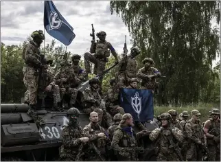  ?? FINBARR O'REILLY — THE NEW YORK TIMES ?? Members of the Free Russia Legion and the Russian Volunteer Corps gather in the Sumy region of Ukraine, May 24, 2023. The soldiers are Russians who have turned against the government of their country's president, Vladimir Putin, and are now fighting for the Ukrainian side by making incursions back into Russia.
