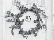  ?? Melissa Aguilar / Houston Chronicle ?? When hanging a wreath on the front door, try centering over the doorknocke­r or house numbers.