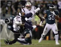  ?? MATT ROURKE - THE ASSOCIATED PRESS ?? New England Patriots’ Tom Brady (12) is tackled by Philadelph­ia Eagles’ Derek Barnett (96) and Nate Gerry (47) during the first half of an NFL football game, Sunday, Nov. 17, 2019, in Philadelph­ia.