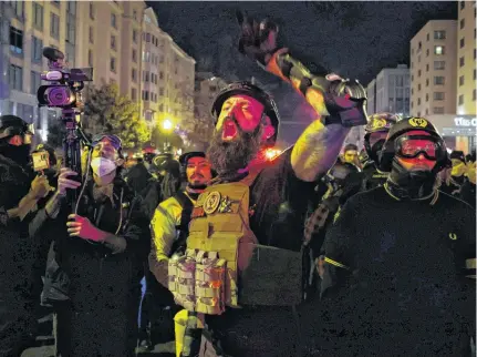  ?? JONATHAN ERNST • REUTERS ?? A member of the far-right group Proud Boys yells at police to let them through as they march on a street near the White House in Washington, D.C., during a rally Saturday to protest the results of the election.