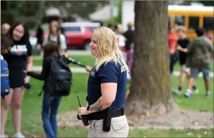  ?? JENNY SPARKS - LOVELAND REPORTER-HERALD ?? Deb Dillon with Safety and Security Patrol for the Thompson School District, keeps and eye on things as students get out of school Thursday at Bill Reed Middle School in downtown Loveland.