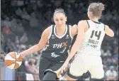  ?? RICK SCUTERI — THE ASSOCIATED PRESS ?? Mercury guard Diana Taurasi drives on Sky guard Allie Quigley (14) during the first half of Game 2 of the WNBA Finals on Wednesday in Phoenix.