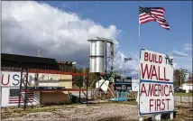  ??  ?? Pro-Trump signage on Maritime Drive in Manitowoc, Wisconsin, shows faith in the president’s signature promise to restore a lost era of American manufactur­ing greatness.