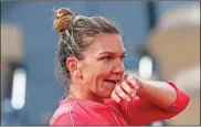  ?? AP-Michel euler ?? Romania’s Simona Halep reacts after missing a shot against Poland’s Iga Swiatek in the fourth round match of the French Open at the Roland Garros stadium on Sunday.