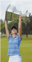  ?? AP PhoTo ?? WELL DONE, DANIELLE: Danielle Kang holds the Women’s PGA Championsh­ip trophy aloft yesterday in Olympia Fields, Ill.