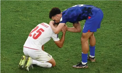  ?? Photograph: Claudio Villa/Getty Images ?? Antonee Robinson consoles Abolfazl Jalali at the end of USA’s victory over Iran at the World Cup.