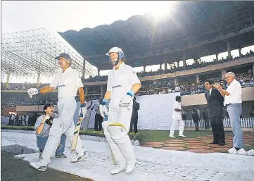  ?? GETTY ?? South Africa openers Jimmy Cook (L) and Andrew Hudson walk out to bat at the Eden Gardens on November 12, 1991 for their first internatio­nal match after a 21-year ban from cricket. Ali Bacher (2nd R) was an UCBSA administra­tor and manager of the team.