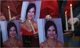  ?? Ireland. Photograph: Clodagh Kilcoyne/Reuters ?? People hold pictures of Ashling Murphy, who was killed in Tullamore while out jogging, during a memorial in Dublin,