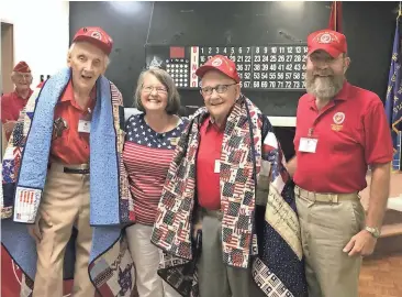  ??  ?? Contribute­d photo
Fran Randolph (second from left) presents quilts to Marine veterans Robert Rakestraw (from left) and Alton Cadenhead. John Riley is the detachment chaplain who made the award nomination­s. DALTON