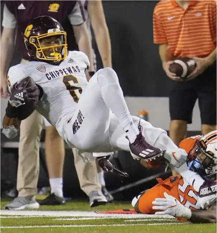  ?? SUE OGROCKI — THE ASSOCIATED PRESS, FILE ?? Central Michigan wide receiver Dallas Dixon (6) is brought down by Oklahoma State cornerback Demarco Jones during the second half of a game last year in Stillwater, Okla.