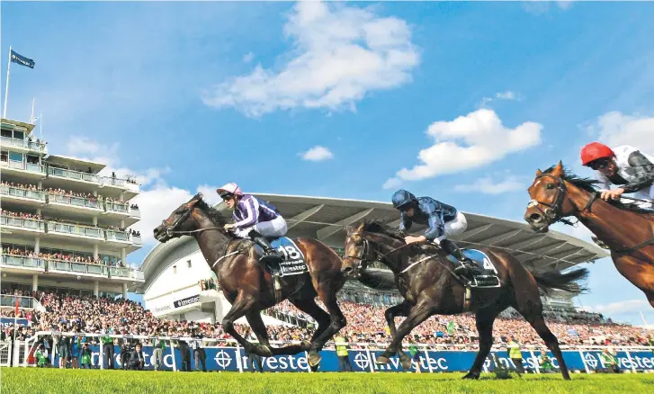  ??  ?? Flying to victory: Jockey Padraig Beggy (left) races ahead on Wings Of Eagles to win the Investec Derby yesterday from Cliffs of Moher (No4) and Cracksman, the 7-2 favourite