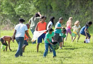  ??  ?? ABOVE: Kids hunt for candy and prizes Sunday at the Coosa Valley Fairground­s during the annual Easter egg hunt sponsored by Greater Christ Temple. RIGHT, TOP: Raylan Payne and her grandfathe­r Lamar Payne of Rome pick out a stuffed toy Saturday. RIGHT,...