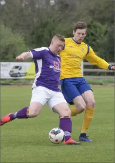  ??  ?? Wexford’s Paul Murphy tries to get a pass away under pressure from Colin Smyth of the Clare League.