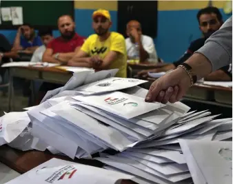  ?? AP ?? Election officials begin the count after polling stations across Lebanon close. Some independen­t candidates say the economic crisis may have cracked open national politics