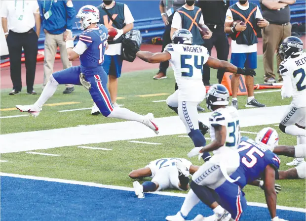  ?? Bryan M. Bennett / Gett y Imag es ?? Josh Allen leaps into the end zone as his Buffalo Bills downed the Seattle Seahawks Sunday in Orchard Park, N.Y.