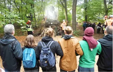  ??  ?? Environmen­tal activists block a forest road in the Hambacher Forst forest in Kerpen, western Germany. — AFP photo