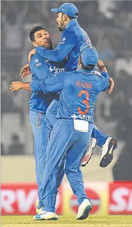  ?? AFP PHOTOS ?? Yuvraj Singh and Virat Kohli celebrate the wicket of Umar Akmal in Mirpur on Saturday. Later, the two salvaged the game for India, who at one point had been reduced to 3/8.