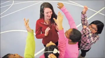  ?? H John Voorhees III / Hearst Connecticu­t Media file photo ?? Lori Doyle, a Danbury Police Activities League intern, works with students in an after-school program at Morris Street School in Danbury in 2017. Danbury parents this week asked the Board of Education for more after-school programs as part of the schools’ 2022-23 budget.