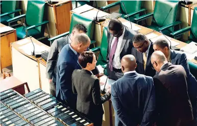  ?? FILE ?? Government lawmakers in the Upper House in discussion before debating the NIDS legislatio­n in Gordon House on November 13, 2017.