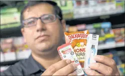  ?? ANDA CHU — STAFF PHOTOGRAPH­ER ?? Najib Siddiqi, owner of the Berryessa Smoke Shop, holds flavored tobacco products that are sold at his shop in San Jose. The city is considerin­g a ban on the sale of flavored tobacco.